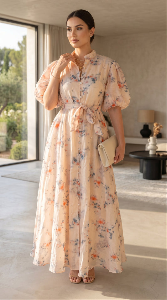 Woman in a floral dress standing in a modern indoor setting