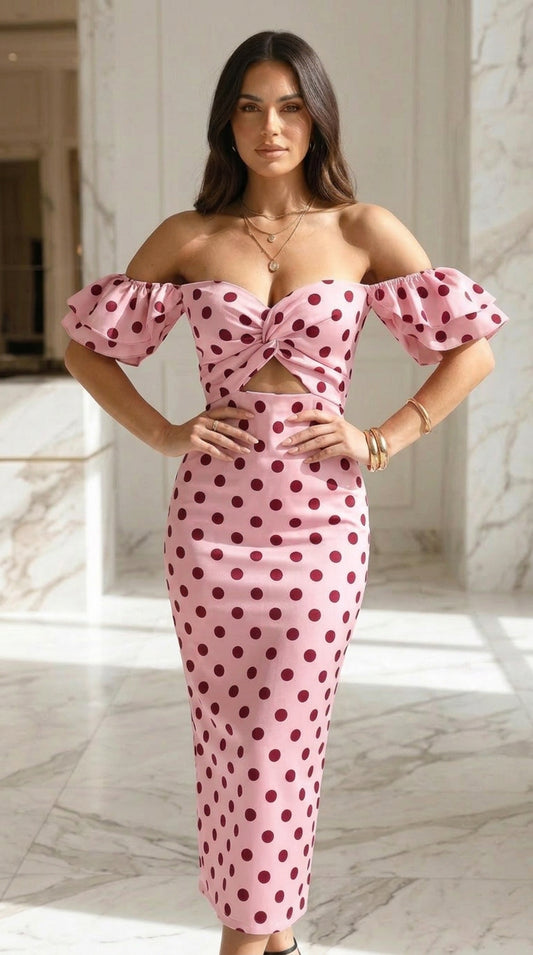 Woman wearing a pink polka dot dress in an elegant interior setting